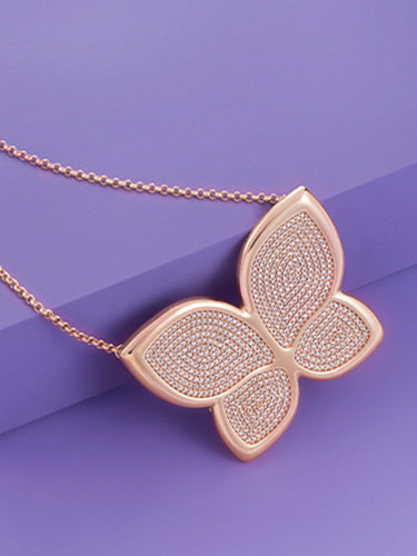 Large gold butterfly pendant necklace encrusted with pave crystals.