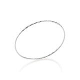 Sterling silver bangle bracelet on a reflective white background showcasing a delicate circular silhouette with an etched diamond-cut texture and high-polish finish